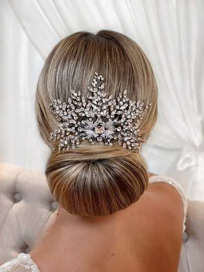 crystal bridal comb tucked in a low bun on a blond bride