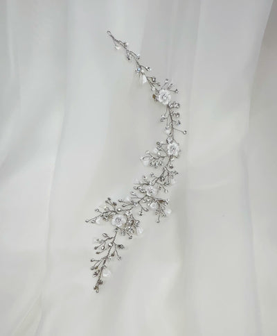 thin asymmetrical bridal hair vine with small crystal sprigs and porcelain flowers