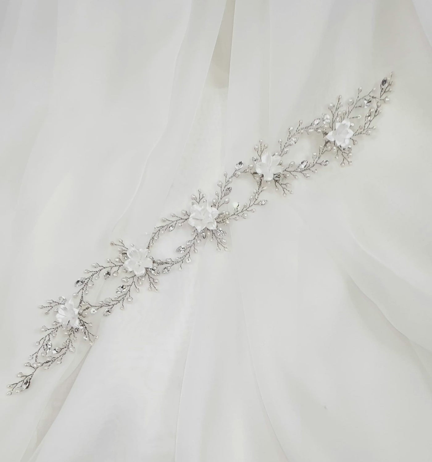 thin looping bridal hair vine with small crystal and pearl details and white porcelain flowers