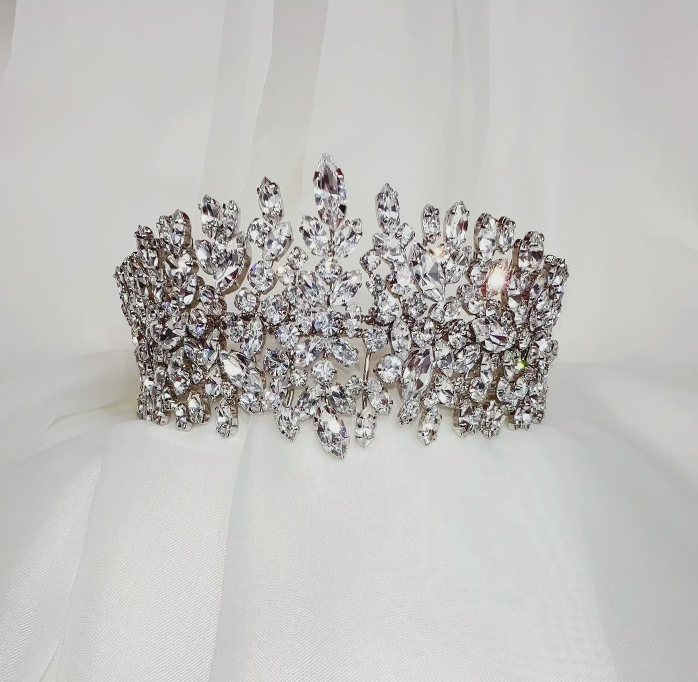 pointed bridal crown made up of round cut sparkling crystal clusters with silver link details