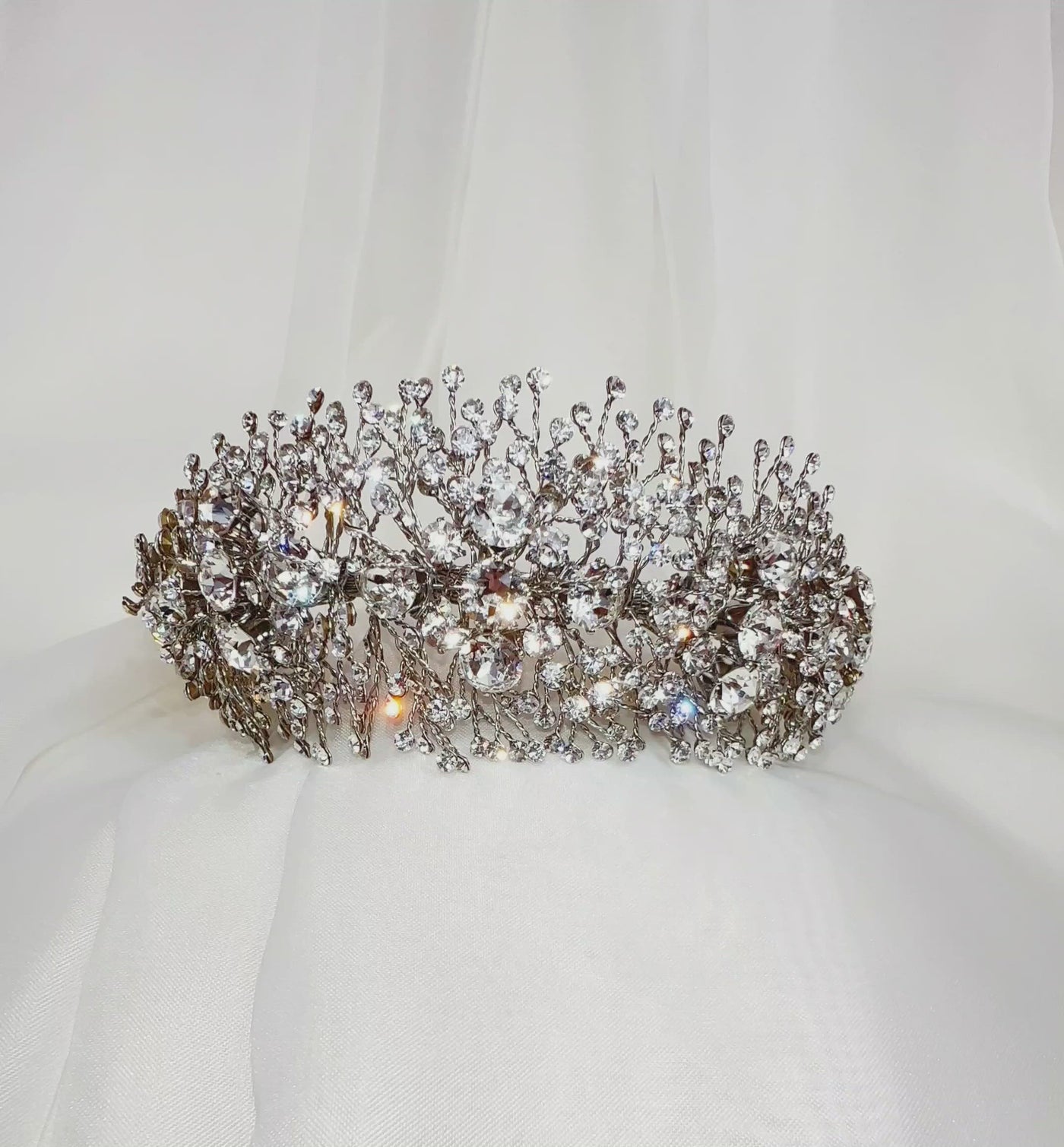 silver bridal headband with large, round crystal and small sprigs