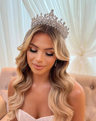 female model wearing tall bridal crown with round crystal peaks and halos