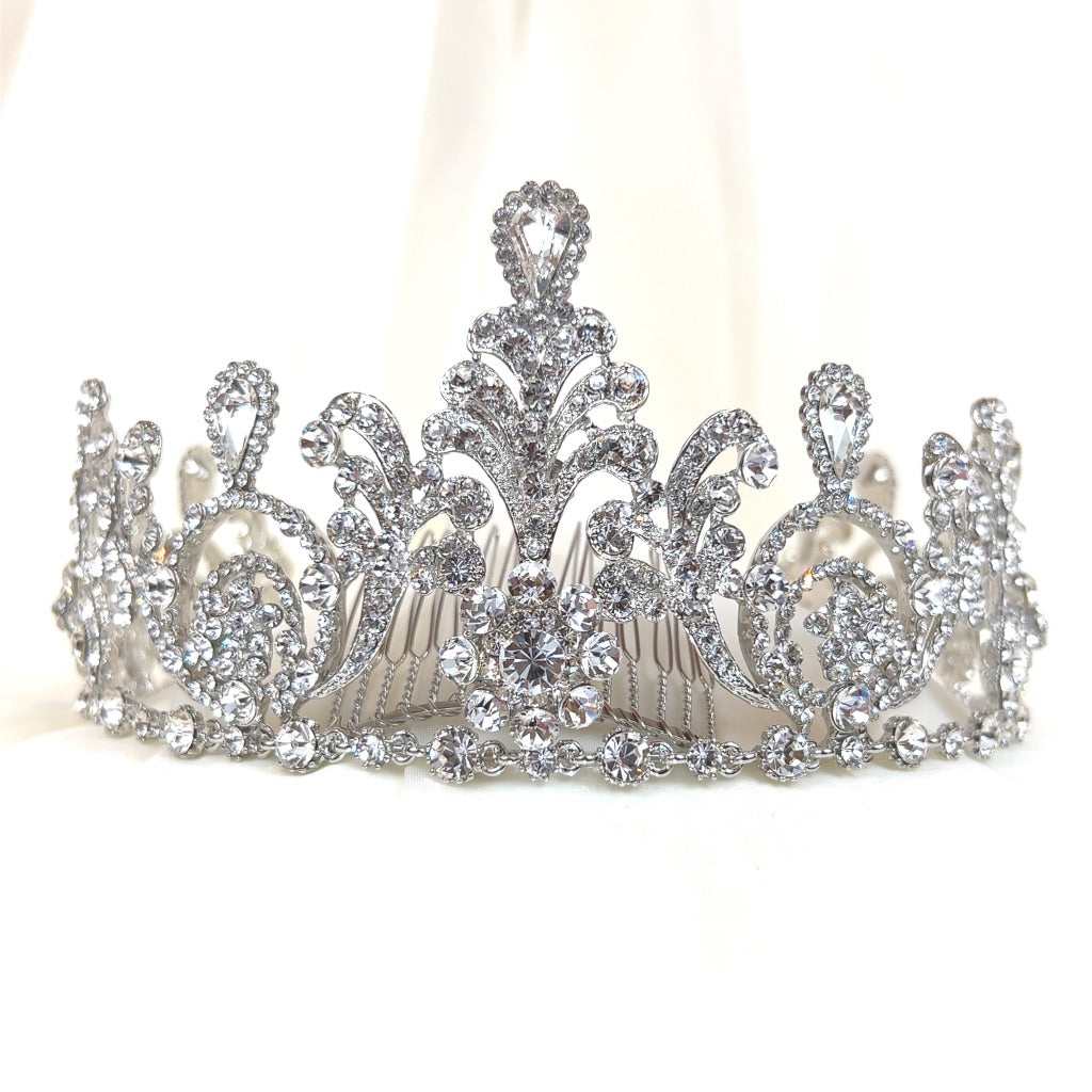 silver bridal tiara with swirling shape, crystal detailing, and added comb
