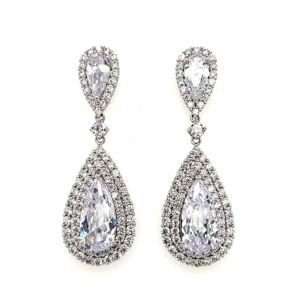 The Glamorous Gold CZ Dangle Wedding Earrings (style E189) feature large clear gemstones encircled by sparkling Cubic Zirconia, set in gold for a radiant bridal look.