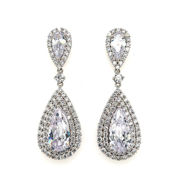 The Glamorous Gold CZ Dangle Wedding Earrings (style E189) feature large clear gemstones encircled by sparkling Cubic Zirconia, set in gold for a radiant bridal look.