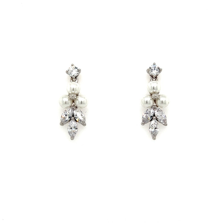 The Dainty CZ Drop Earrings (style no. E192) feature a round diamond, three pearls in the middle, and leaf-shaped diamonds below, shown on a white background. Perfect for enhancing any bridal jewelry collection with sophistication.