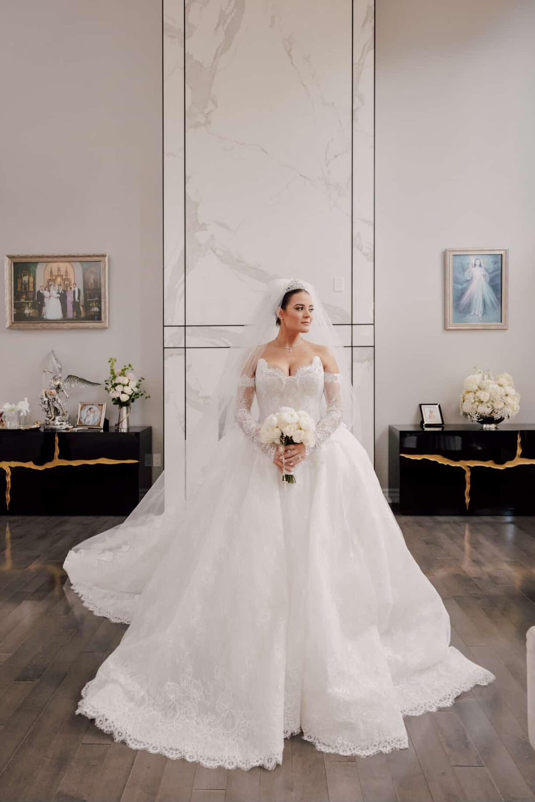 Bride Laura in pearl-embellished lace ballgown with crystal tiara, cathedral veil, and white rose bouquet at formal bridal portrait