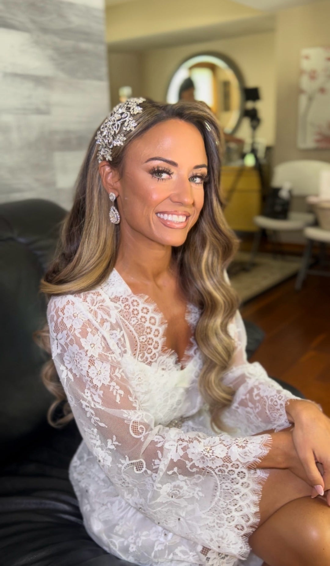 Bride Suzanne wearing a lace illusion sleeve wedding robe, custom crystal bridal comb and teardrop earrings.