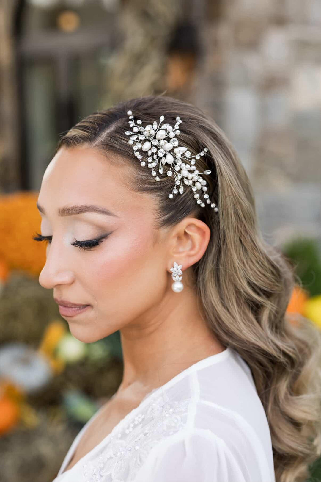 Real bride Amanda wearing a custom pearl and Swarovski crystal bridal hair comb styled in soft waves