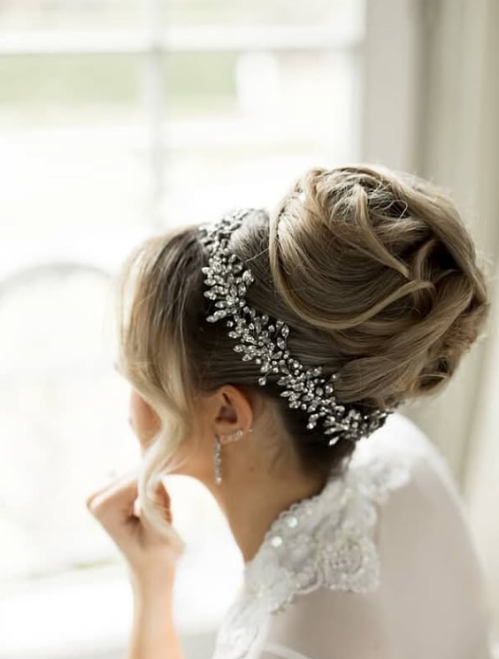 Bride with high updo hairstyle accented with a Swarovski crystal wedding halo