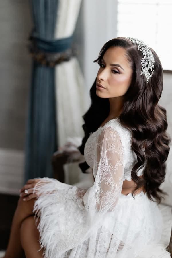 Real bride Massiel wearing her Swarovski crystal headband and bold vine CZ wedding earrings from Bridal Styles Boutique with feathered lace bridal robe.