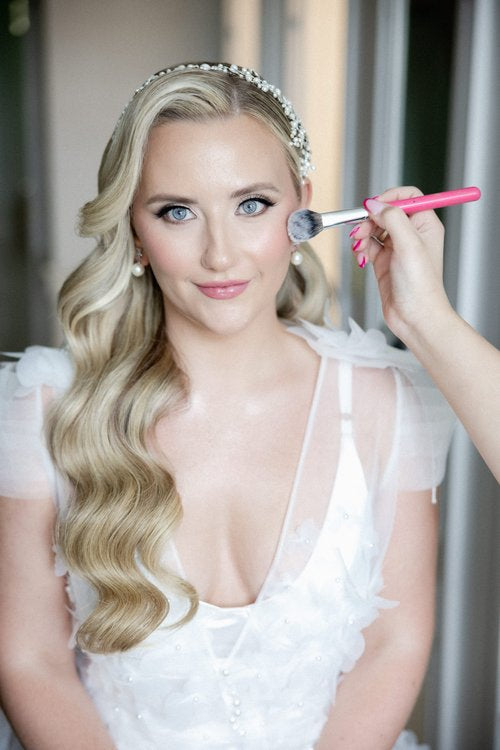 Real bride Sabina getting ready for her wedding, wearing a pearl and crystal bridal hair vine by Bridal Styles Boutique.