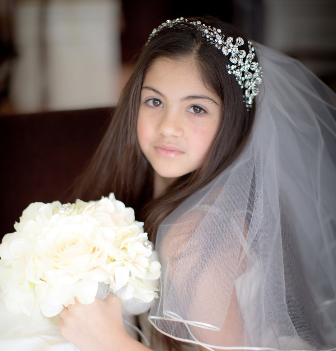 Close-up of ribbon edge communion veil with crystal headband and white flowers