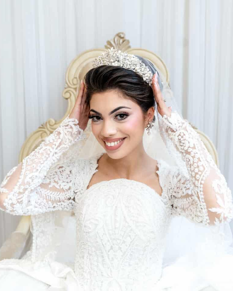 Bride fixing her pearl and crystal bridal crown by Bridal Styles Boutique