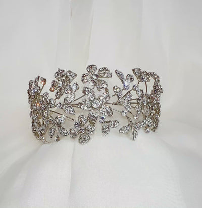 silver bridal headband with various flower details encrusted with sparkling crystals
