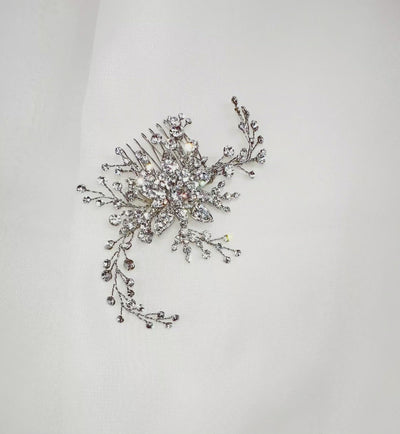 silver bridal hair comb with a single crystalized flower and curved sprigs of round, sparkling crystals