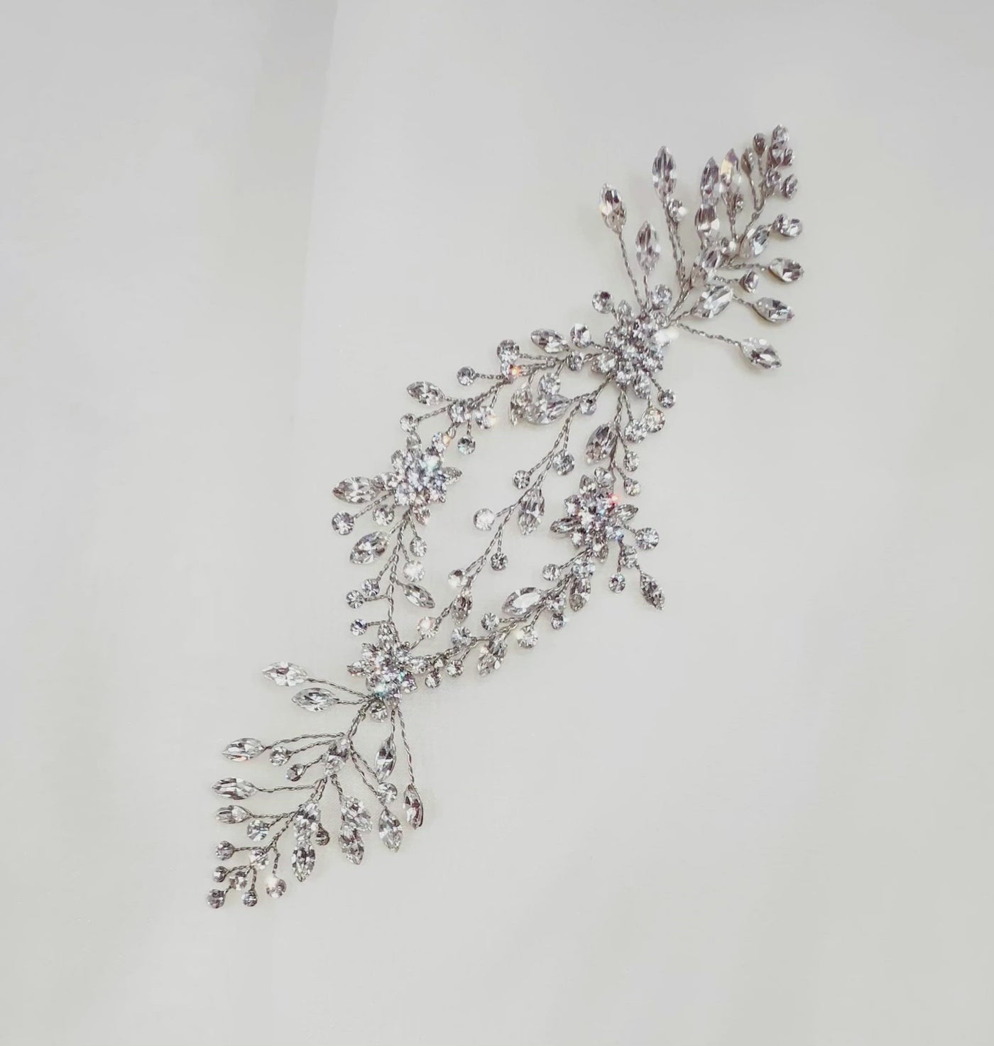 short silver bridal hair vine with sparkling crystal sprigs and flower details