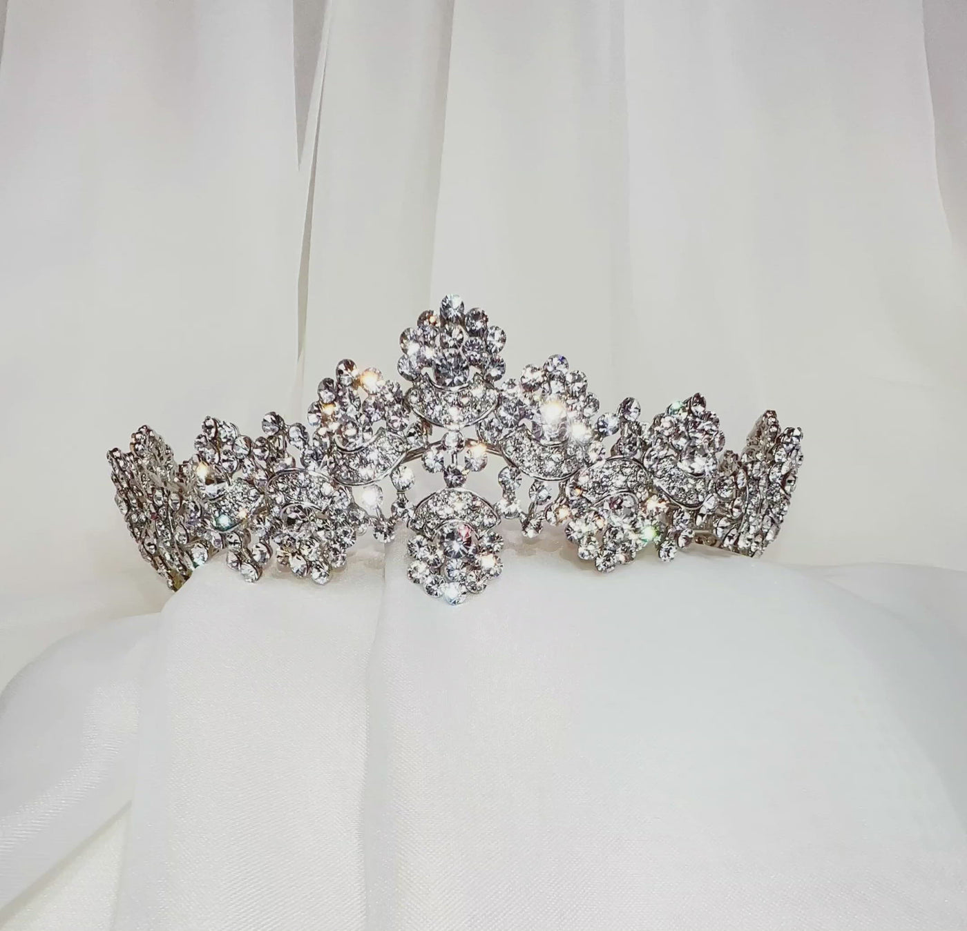 bridal tiara with swirling silver shape and sparkling round clusters of crystal