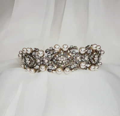 bridal headband with antique gold swirling and floral detailing surrounding sparkling, round crystals and large pearls