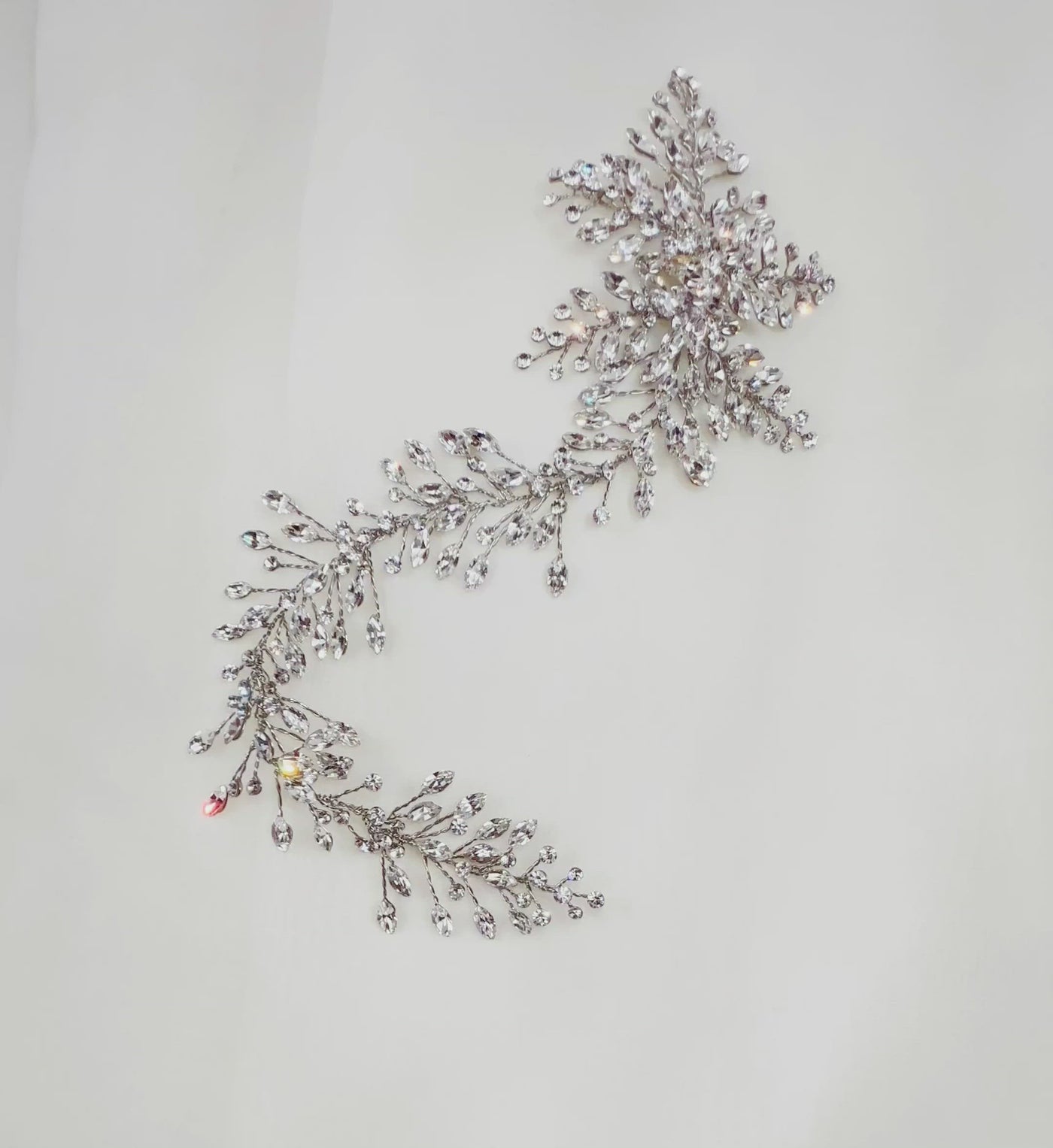 silver asymmetrical bridal hair vine with small sprigs of oval crystals