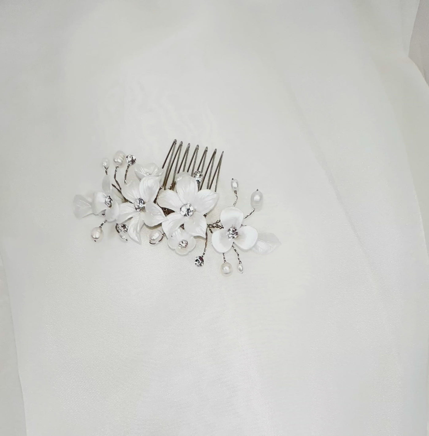 single porcelain flower bridal hair comb with small sprigs of crystal and pearl
