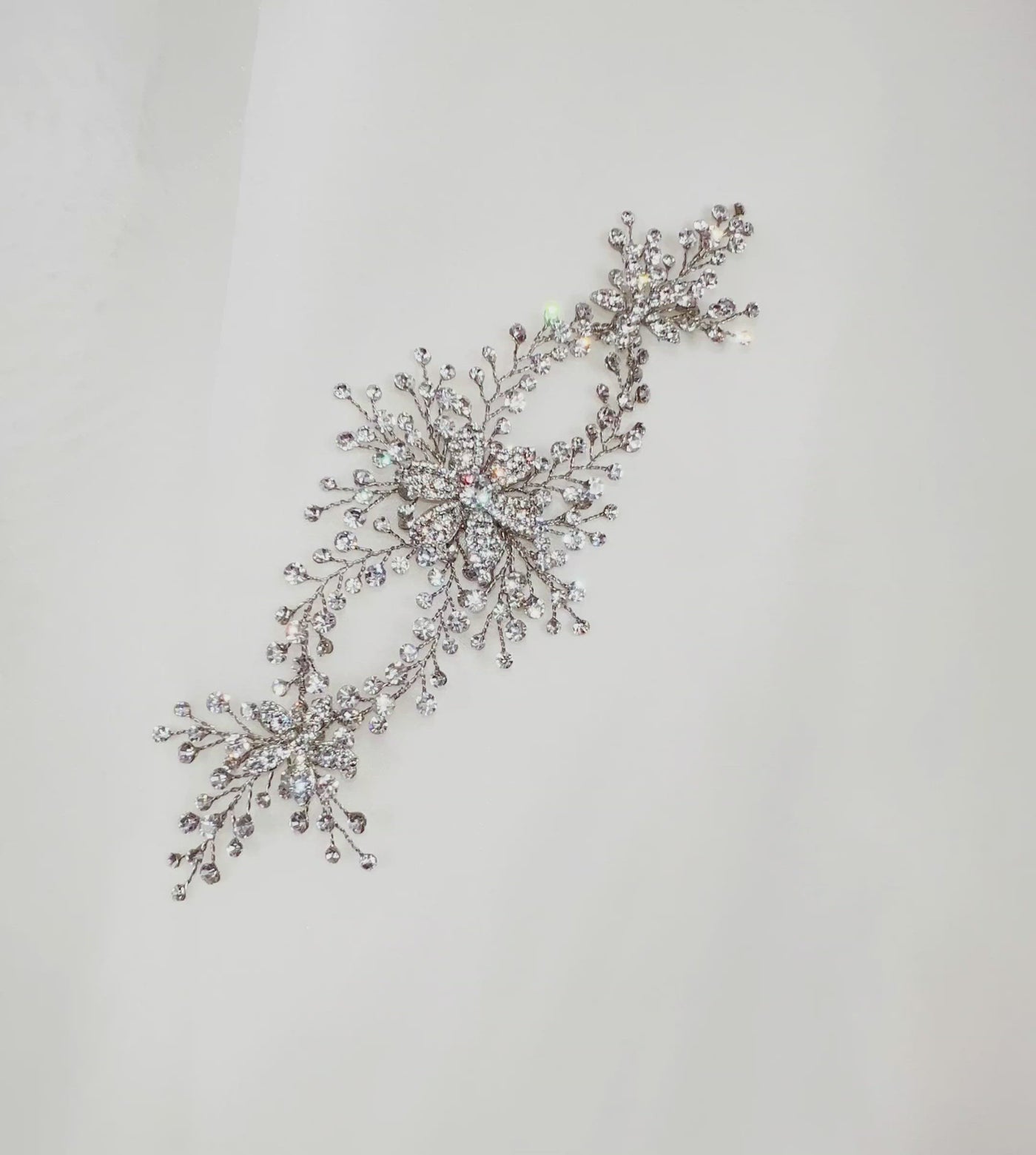 double loop silver bridal hair vine with crystalized flower details and sparkling sprigs of round crystals