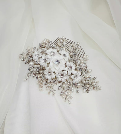 bridal hair comb with white porcelain flowers surrounded by sprays of pearl and sparkling crystals