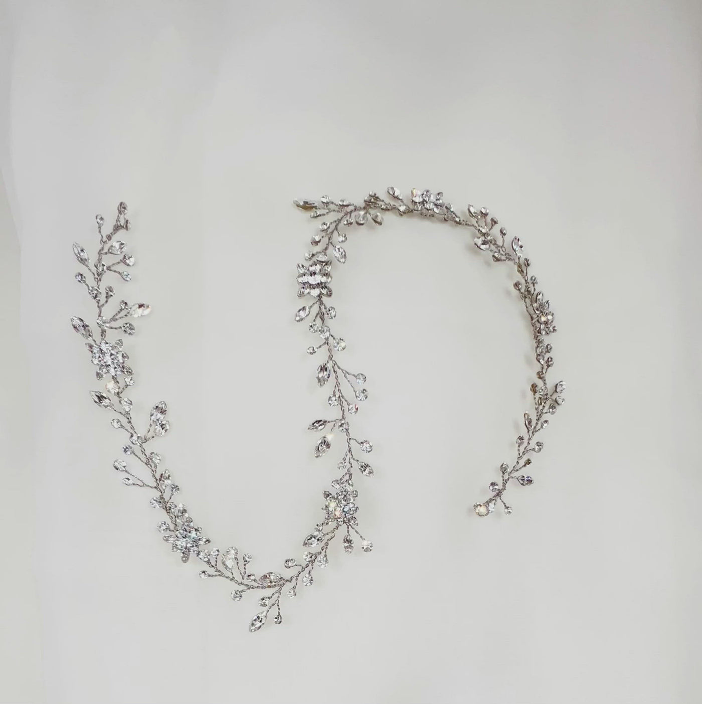 thin silver bridal hair vine with small crystal sprigs and sparkling flower details
