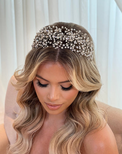 female model wearing wide bridal headband with crystals and pearls on weaving silver sprigs