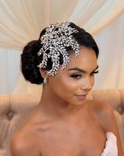 female model wearing bridal comb with swirling silver detailing and sweeping crystal sprays