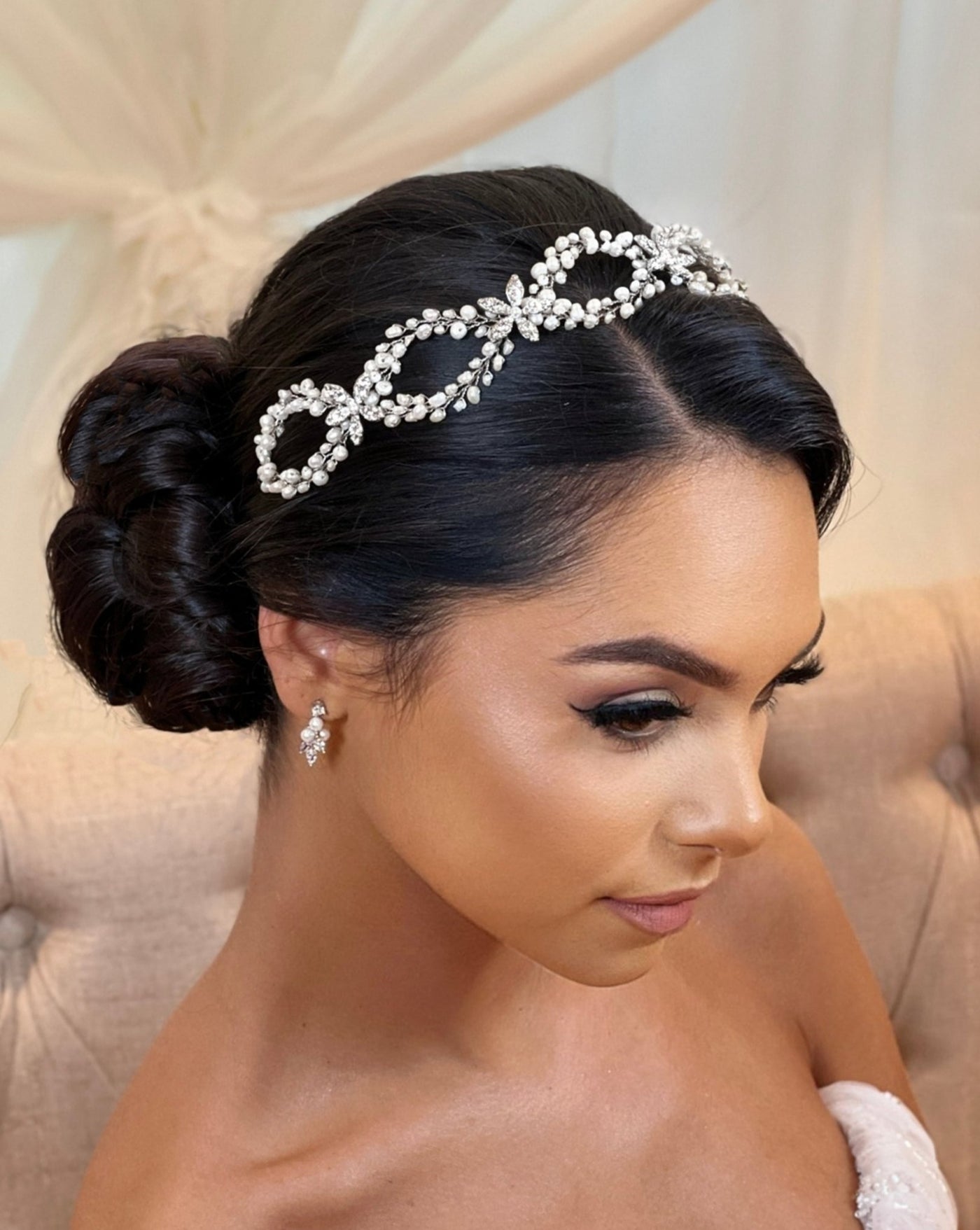 female model wearing bridal looping pearl hair vine with silver flower details