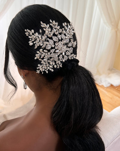 female model wearing floral bridal hair comb with long sprays of crystals and pearls above a ponytail