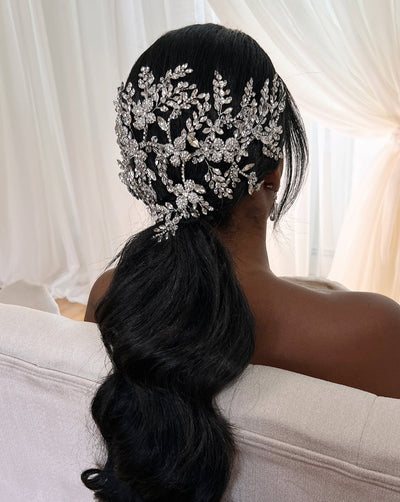 female model wearing wide bridal hair piece with large floral branches of crystal