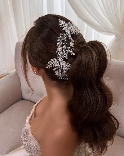 female model wearing silver loop bridal hair vine with crystal and pearl branches and flower details
