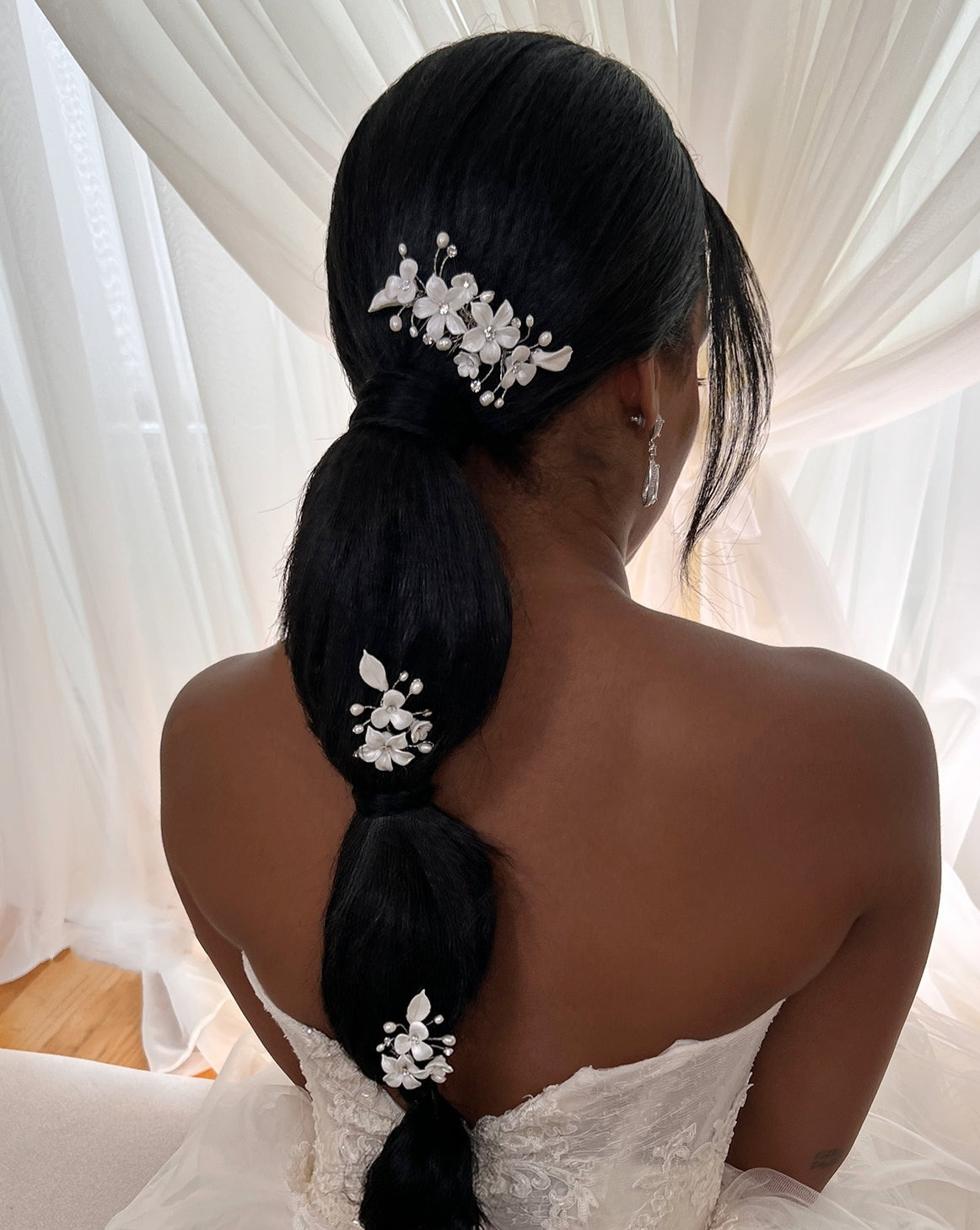 female model wearing porcelain flower bridal comb and two porcelain flower pins in a ponytail