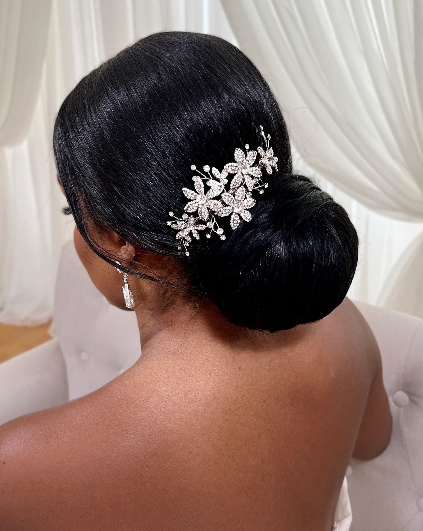 female model wearing silver bridal hair comb with crystalized flowers and small sprigs of crystal