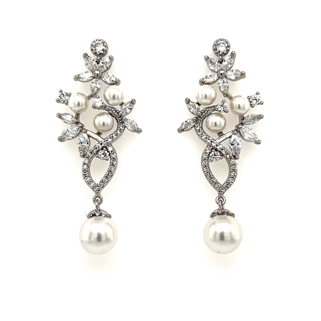 The Vintage-inspired CZ and Pearl Wedding Earrings (style no. E212) feature silver metal, sparkling crystals, and white pearls in a floral leaf design with a large suspended pearl—perfect for bridal wear.
