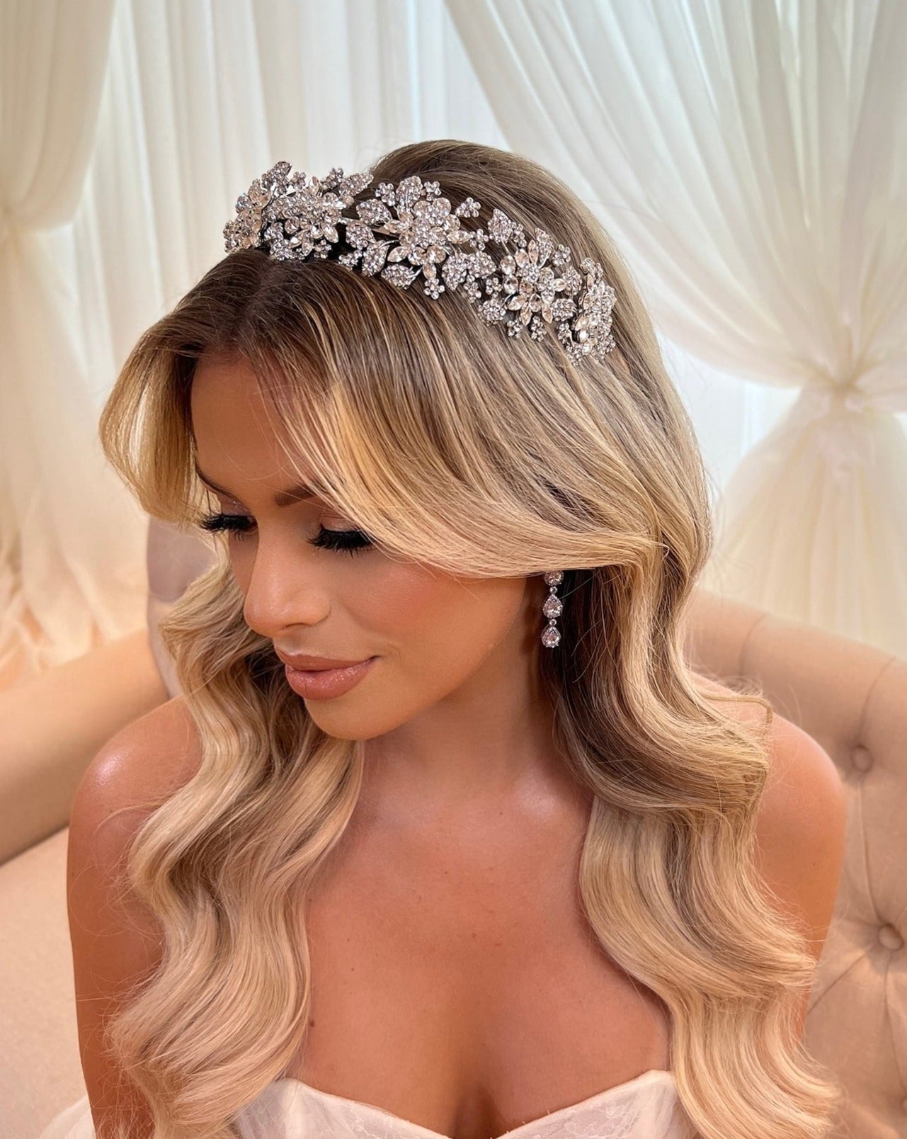 female model wearing floral bridal headband with various crystal flowers and small clusters