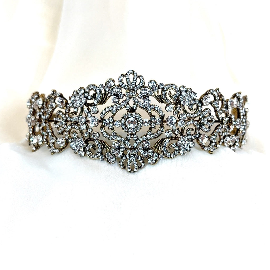 The Vintage Inspired Swarovski Crystal Headband, style no. 80107, is an ornate and statement-making bridal headpiece featuring intricate, vintage-inspired motifs. 