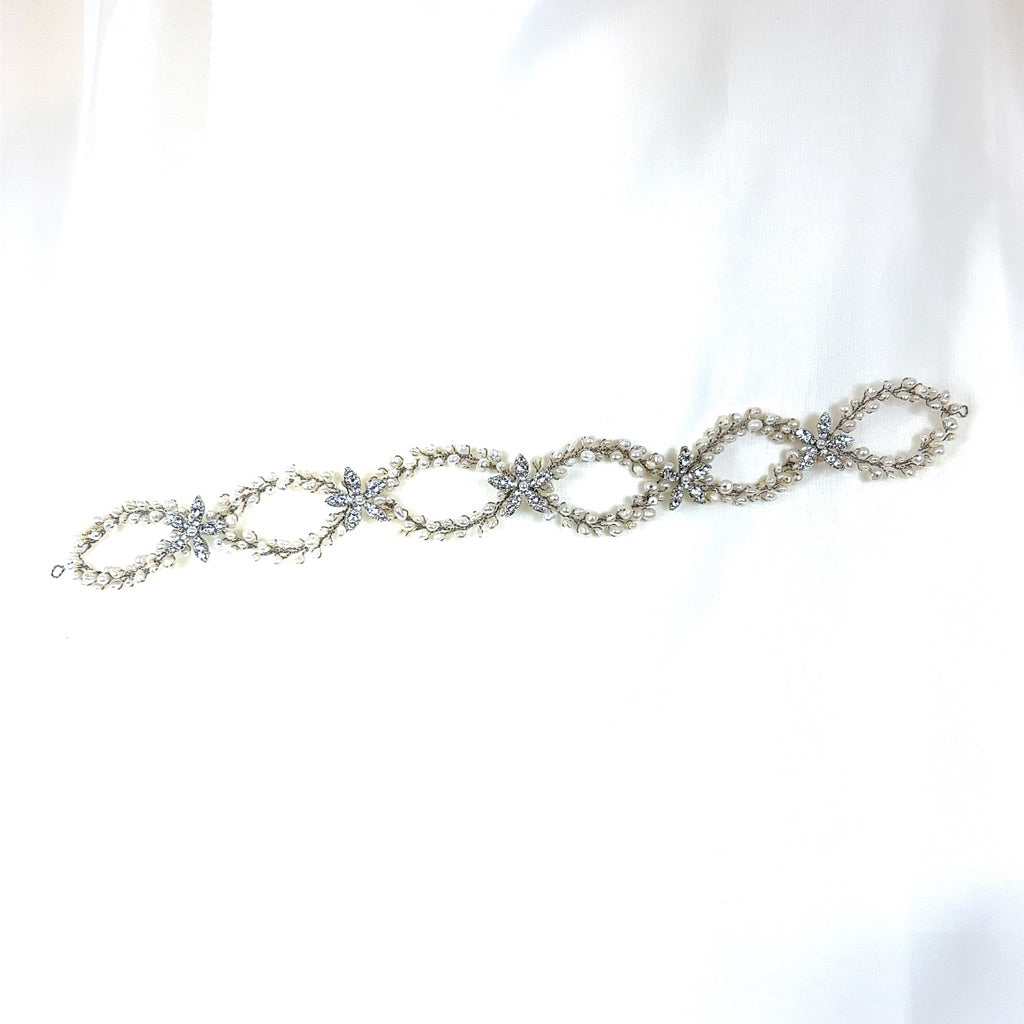The Classy Pearl and Flower Looping Vine style no. 242708 is a delicate Swarovski crystal bridal headpiece  with interlocking oval links adorned with small, lustrous pearls and dazzling crystals  that embodies elegance.