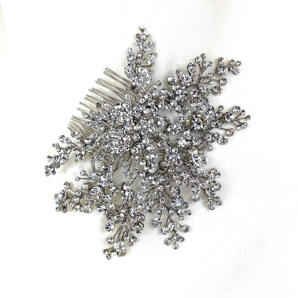 bridal hair comb with circling silver details at its center and branches of round crystals