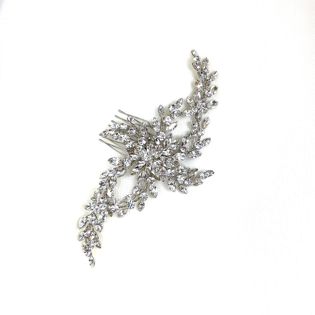 The Delicate Flowing Swarovski Crystal Hair Comb, style no. 242603, features a shimmering design of intricate leaf and flower motifs made from sparkling crystals.