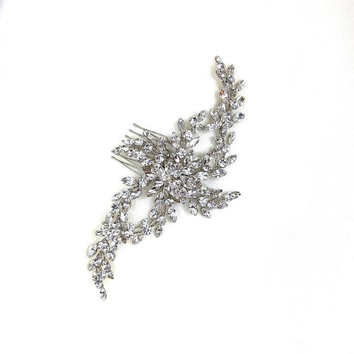 The Delicate Flowing Swarovski Crystal Hair Comb, style no. 242603, features a shimmering design of intricate leaf and flower motifs made from sparkling crystals.