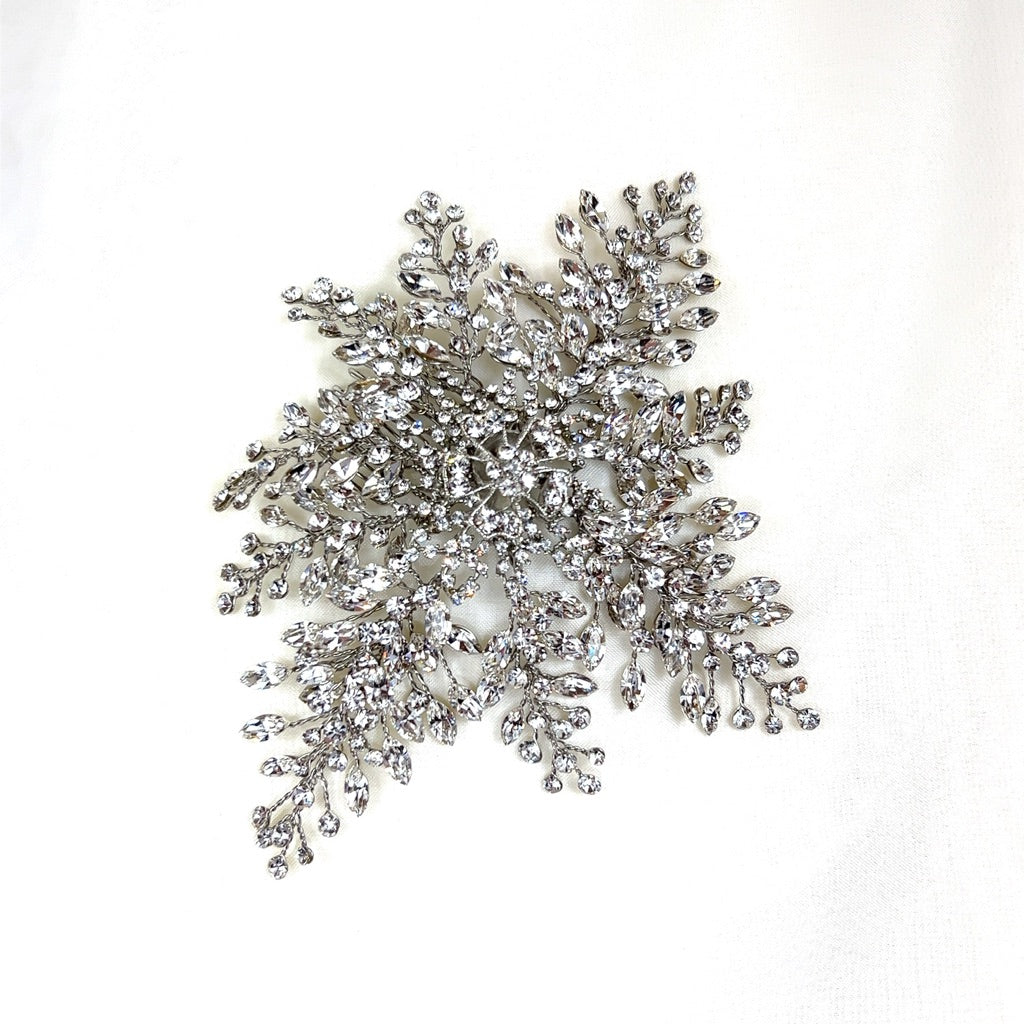 bridal hair comb with silver floral detailing and dramatic crystal sprays