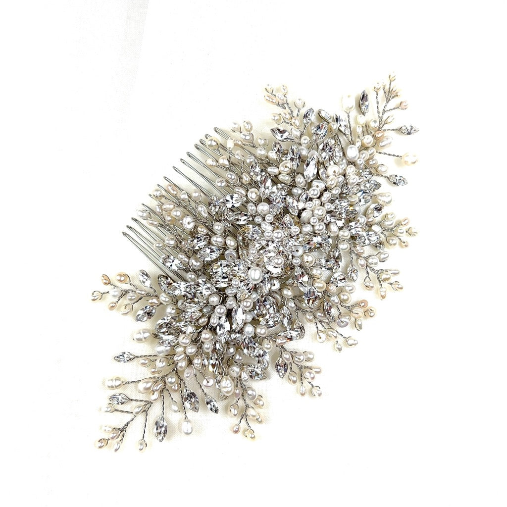 The Classic Swarovski Crystal Hair Comb (style no. 242646) is a wedding hairpiece adorned with sparkling  crystals and delicate white pearls, crafted in a detailed floral pattern.