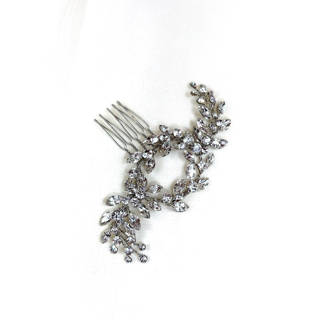 The Dainty Crystal Comb (style no. 242615) is a perfect Swarovski bridal hair comb choice, featuring branches encrusted with crystals and resembling leaves and flowers for an elegant look.