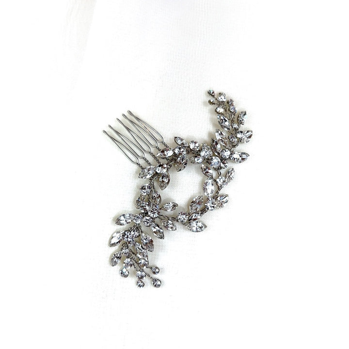 The Dainty Crystal Comb (style no. 242615) is a perfect Swarovski bridal hair comb choice, featuring branches encrusted with crystals and resembling leaves and flowers for an elegant look.
