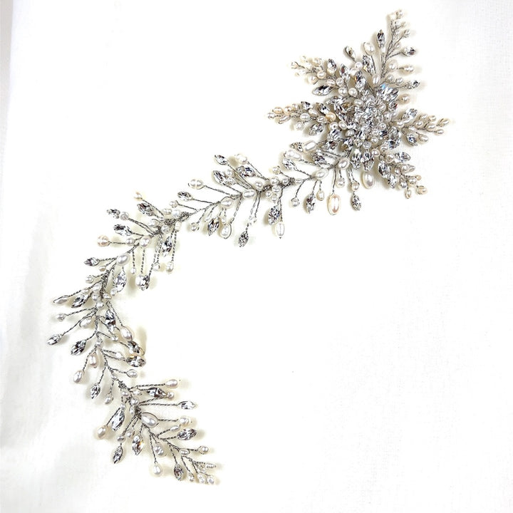 The Romantic Asymmetrical Vine (style no. 242552) is a Swarovski crystal and pearl floral bridal hair accessory with intricate leaf and flower details. It is beautifully presented on a white background.