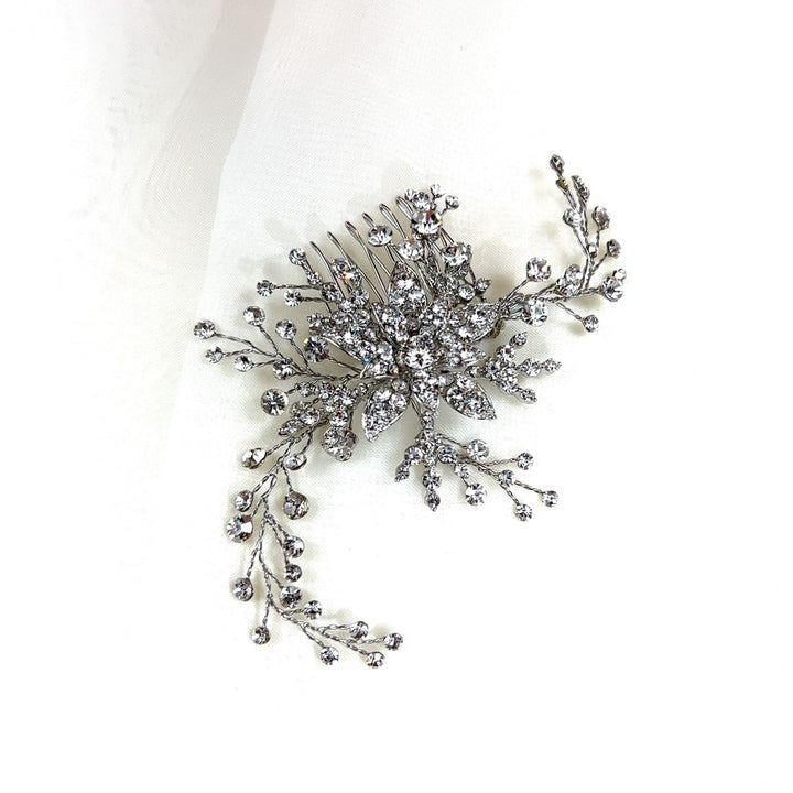 The Delicate Flower Swarovski Crystal Hair Comb (style no. 242697) features Swarovski crystals on metal with shaped like branches and flowers.