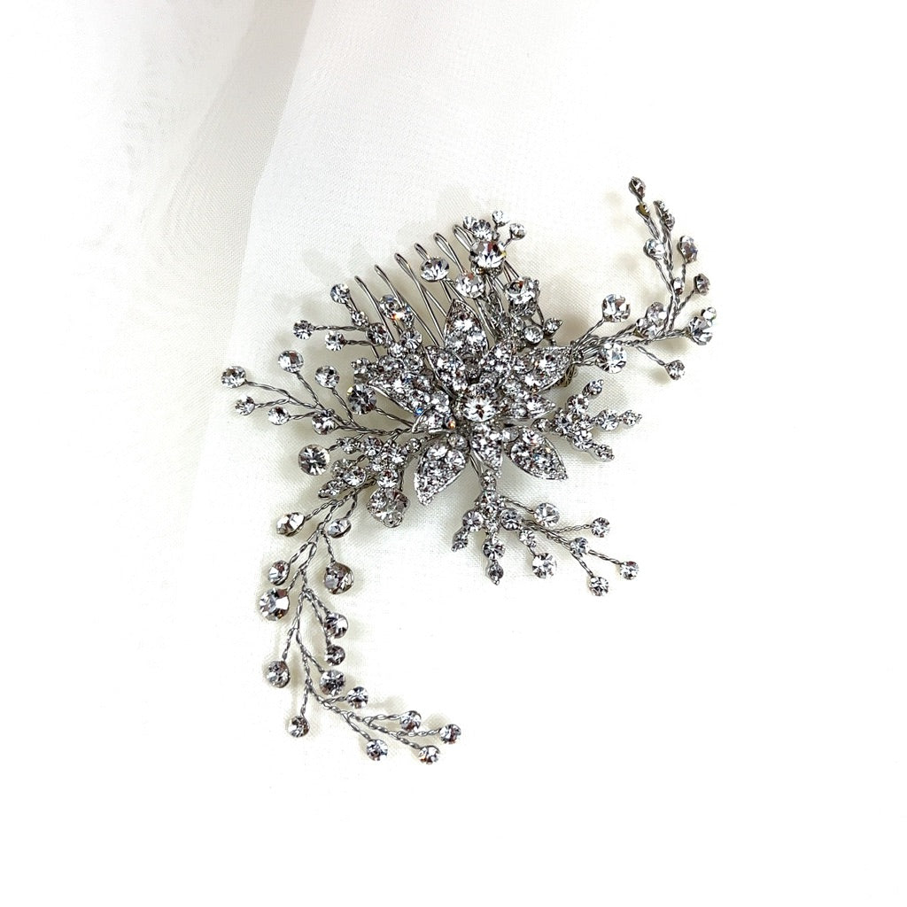 silver bridal hair comb with a single crystalized flower and curved sprigs of round crystals